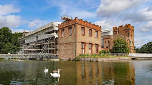 A view of the moat and the Roof Project conservation work at Oxburgh Hall